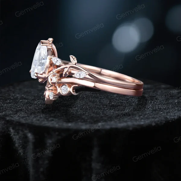 Side profile of 14K rose gold pear moissanite engagement ring showing twisted leaf vine band with stars moon accents, handcrafted nature bridal ring set with detailed metalwork