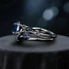 Side profile view of the black gold blue sapphire ring set, highlighting the twig vine detailing along the band and the thickness of the wedding band.