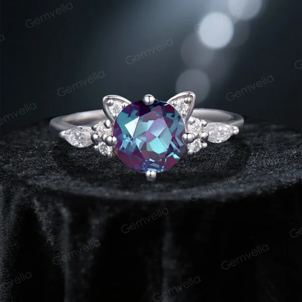 Detailed close-up of the main solitaire cat engagement ring, focusing on the clarity and cut of the round color-change alexandrite center stone surrounded by moissanite stones.