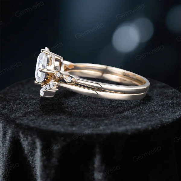 Side view of the cat-themed moissanite ring, highlighting the slim yellow gold band, the height of the round-cut center stone, and the delicate cat ear detailing on the setting.