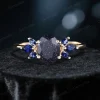 variation of galaxy starry sky ring showcasing 1.5ct oval blue sandstone main stone paired with deep blue sapphire side stones.