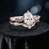 Angled view of the 1.25ct pear cut moissanite engagement ring set, displaying the leaf vine and branch twist band design from a 45-degree perspective to show depth and detailing