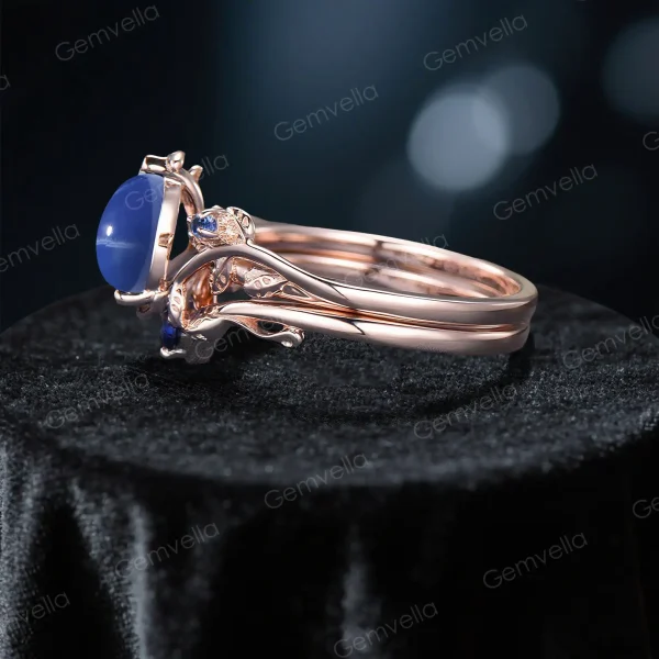 Side profile of the handmade leaf bridal set showing the intricate branch detailing and the height of the pear-cut blue sapphire setting.