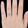 Close-up shot of a woman's hand wearing the 1.5ct oval moissanite ring with marquise accents, displaying the ring's elegant look on the finger as a perfect engagement gift.