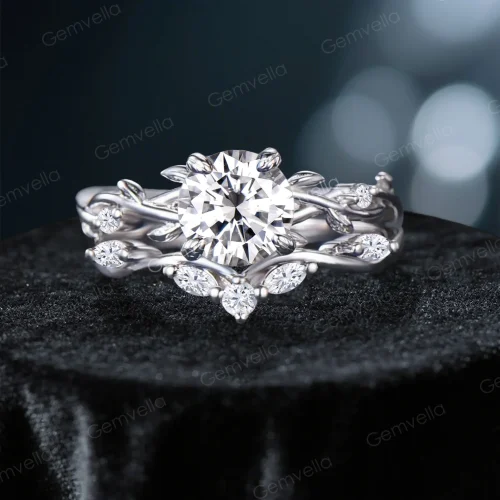 Front view of a vintage-inspired 1.2ct round cut moissanite engagement ring set featuring a twisting vine leaf band with pave accents.