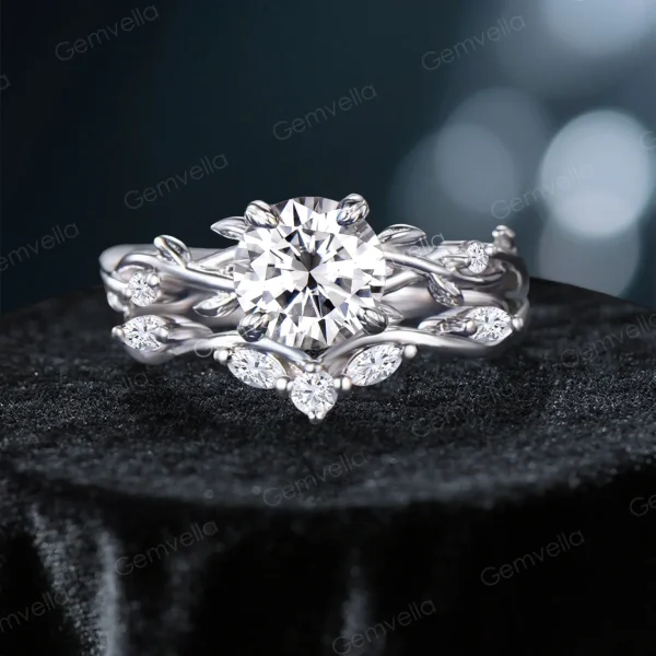 Front view of a vintage-inspired 1.2ct round cut moissanite engagement ring set featuring a twisting vine leaf band with pave accents.