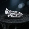 Side profile showing the intricate twisting vine leaf band and the gallery height of the 1.2ct round moissanite engagement ring.