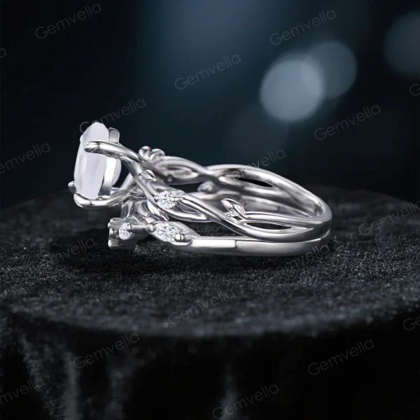 Side profile showing the intricate twisting vine leaf band and the gallery height of the 1.2ct round moissanite engagement ring.