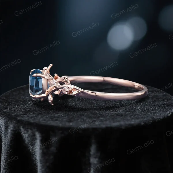 Side profile of the 1ct London Blue Topaz and Moonstone ring, displaying the rose gold band thickness, prong setting height, and vintage-inspired metalwork.