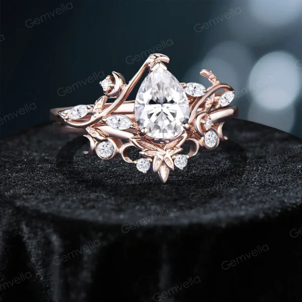 Angled view of 14K rose gold pear cut moissanite ring displaying stars moon and twisted vine design, handcrafted nature inspired bridal engagement ring set with three-dimensional details