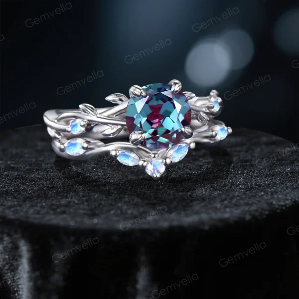 45-degree angle shot revealing the three-dimensional depth of the leaf and vine motif, the sparkle of the central Alexandrite, and the ethereal blue sheen of the surrounding Moonstones.
