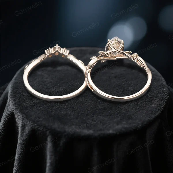Overhead shot of the nature inspired moissanite bridal set displaying the intricate twig design, the width and thickness of the rose gold band, and the brilliant cut of the pear shaped center stone.