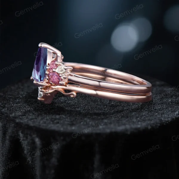 Side - on profile of the 1.25ct pear alexandrite ring set. See the depth of the pear - cut alexandrite, the cluster setting of pink tourmaline and moissanite on the main ring, and the delicate branch - leaf structure of the moissanite - set band.