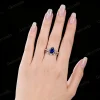 Lifestyle image of a woman's hand wearing the 1.25ct pear cut blue sapphire ring, highlighting the sterling silver nature twig design as an anniversary or engagement gift.
