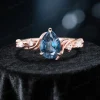 Close up front view of the main 1.25ct pear cut London Blue Topaz solitaire ring with prong setting.