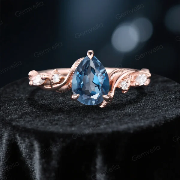Close up front view of the main 1.25ct pear cut London Blue Topaz solitaire ring with prong setting.