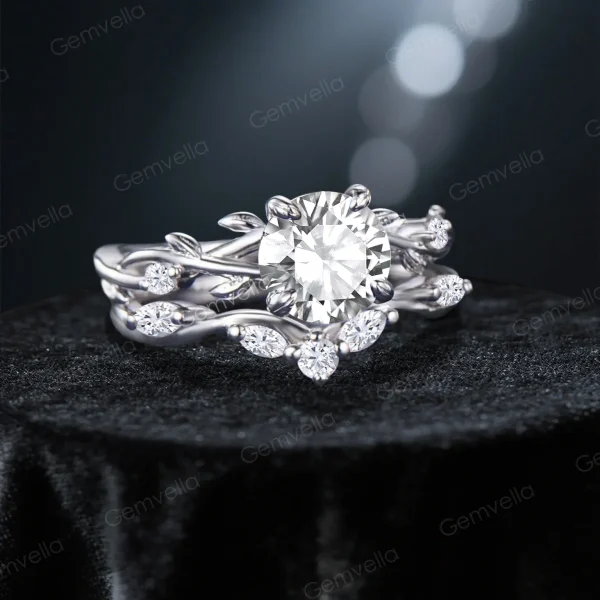 Angled view highlighting the brilliance of the round cut moissanite and the organic texture of the handcrafted vine leaf design.