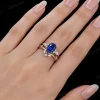 Woman's hand wearing the Blue Sapphire and moissanite bridal set, showing the ring size and sparkle on finger.