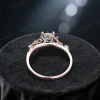 Top-down view of the rose gold ring highlighting the band width and thickness, with the 1ct round London Blue Topaz and Blue Sapphire centerpiece visible.