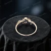 Top down view showing the band width and thickness of the moss agate engagement ring. The image details the sturdy vintage setting, the round cut agate center, and the placement of emerald accents on the moon star design.