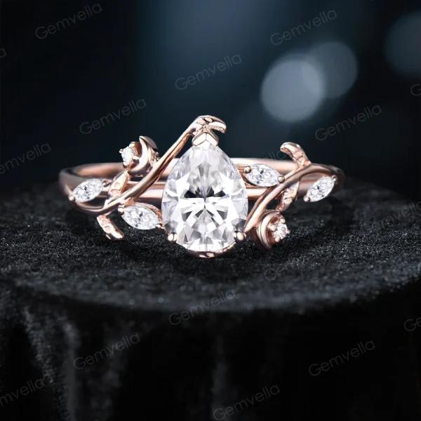 Front view of main 14K rose gold pear cut moissanite ring showing primary stone with stars moon and twisted vine setting, handcrafted bridal engagement ring with prominent center piece