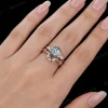 Woman's hand wearing the natural green moss agate and moissanite bridal set, showing the ring size and sparkle on finger.