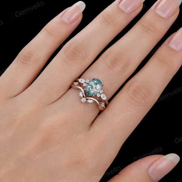 Woman's hand wearing the natural green moss agate and moissanite bridal set, showing the ring size and sparkle on finger.