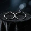 Top down view showcasing the band width and thickness of the black gold blue sapphire ring set, revealing the sturdy construction and twig vine detailing on the wedding band.