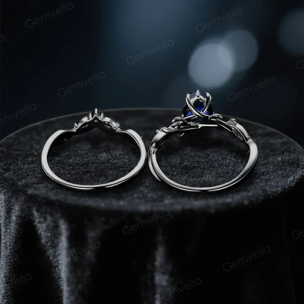 Top down view showcasing the band width and thickness of the black gold blue sapphire ring set, revealing the sturdy construction and twig vine detailing on the wedding band.