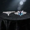 Flat lay photography of the complete cat themed bridal set, displaying the round alexandrite engagement ring paired with the matching moissanite wedding band.
