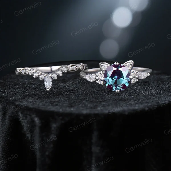 Flat lay photography of the complete cat themed bridal set, displaying the round alexandrite engagement ring paired with the matching moissanite wedding band.