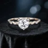 Detailed front view of the main cat-themed engagement ring, focusing on the round-cut moissanite center stone, the cat ear-shaped prongs, and the sparkling side stones in 14K yellow gold.