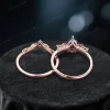 Top - down perspective of the 1.25ct pear alexandrite ring set, highlighting the width and thickness of the rose gold bands. The main ring’s cluster of pink tourmaline and moissanite, and the band’s leaf - branch moissanite pattern are clearly visible.