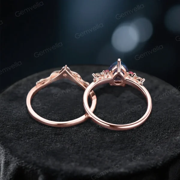 Top - down perspective of the 1.25ct pear alexandrite ring set, highlighting the width and thickness of the rose gold bands. The main ring’s cluster of pink tourmaline and moissanite, and the band’s leaf - branch moissanite pattern are clearly visible.