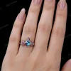 Woman's hand wearing vintage art deco kite alexandrite and amethyst wedding ring, close up lifestyle image.