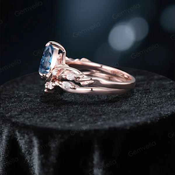 Side profile showing the intricate branch and leaf twist band design of the silver London Blue Topaz wedding ring set.