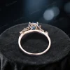 Top-down view of the rose gold ring highlighting the band width and thickness, with the 1ct round London Blue Topaz and Moonstone centerpiece visible.