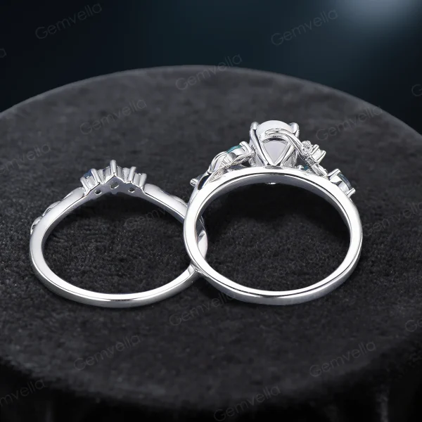 Top view of nature inspired opal bridal ring set, showing the 10K rose gold leaf vine branch band width and thickness, with central oval opal and emerald accents visible