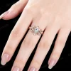 Close-up of 14K rose gold pear moissanite ring worn on hand, real life wear of stars moon and twisted vine engagement ring, nature inspired bridal jewelry showing fit and sparkle