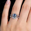 Lifestyle close-up of the vintage Alexandrite and Moonstone ring set worn on a woman's finger, demonstrating how the twisting vine design wraps elegantly around the hand and complements the skin tone.