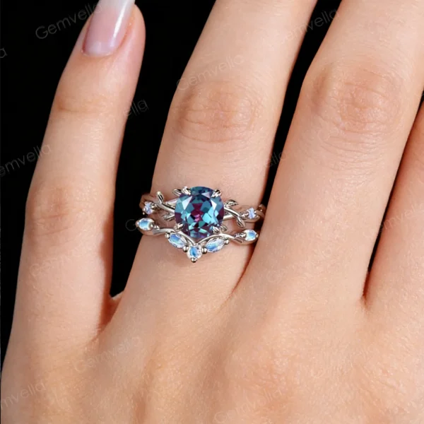 Lifestyle close-up of the vintage Alexandrite and Moonstone ring set worn on a woman's finger, demonstrating how the twisting vine design wraps elegantly around the hand and complements the skin tone.