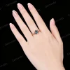 Close - up of the 1.25ct pear alexandrite engagement ring set worn on a hand. The main ring’s cluster of pink tourmaline and moissanite, and the delicate leaf - branch moissanite band are shown in a natural, everyday - wear setting.