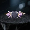 variation of blue sandstone engagement ring featuring 1.5ct oval center stone surrounded by purple amethyst accent gems