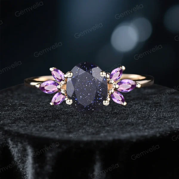 variation of blue sandstone engagement ring featuring 1.5ct oval center stone surrounded by purple amethyst accent gems
