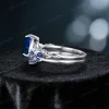 Side profile of the 1.25ct blue sapphire ring set, highlighting the height of the pear-cut sapphire setting, the textured twig and leaf detailing along the sterling silver band, and the comfortable fit of the wedding band.