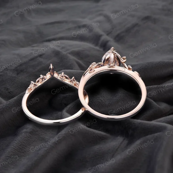 Top-down view of a 1.25ct pear moissanite bypass ring showing the band width and thickness, 14K rose gold construction with leaf vine detailing, highlighting the comfortable fit and quality craftsmanship of the nature-inspired wedding ring.