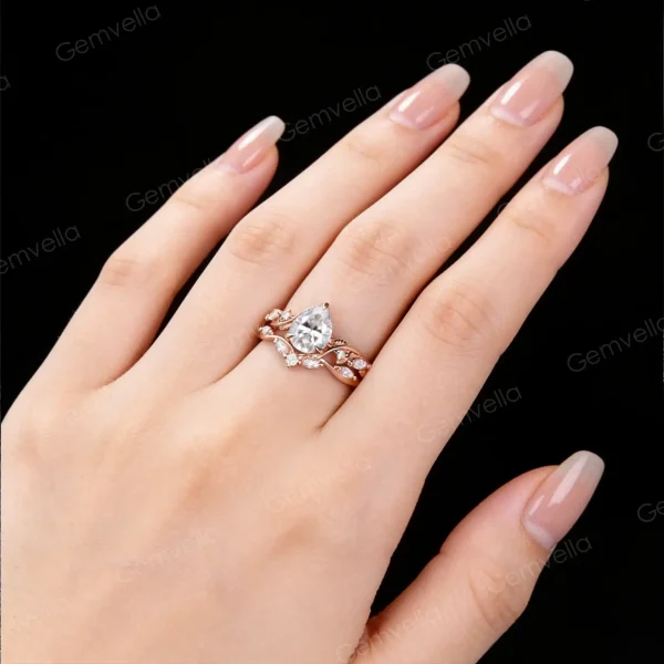 Real-life image of a woman wearing the 1.25ct pear cut moissanite engagement ring set, showcasing how the nature inspired leaf vine and branch twist band looks on the finger