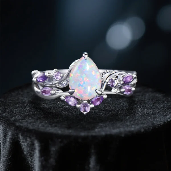 Nature-inspired engagement ring set with 1.25ct pear-cut opal in silver finish, twig and vine botanical design