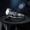 Side profile of nature-inspired engagement ring set with 1.25ct pear-cut opal in black gold, featuring delicate twig and vine design