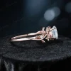 Side profile of a vintage 14k gold moissanite engagement ring, highlighting the thickness of the band and the detailed craftsmanship of the floral leaf and vine branch design wrapping around the shank.